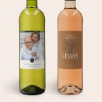 A Maison de la Surprise wine gift set with personalised labels. The white wine features a printed photo of a couple with "50 LEWIS'S VINEYARD AMSTERDAM BLEND" text, and the rosé wine has "FINEST SELECTION LEWIS 1974 LONDEN AWARD WINNING" text.