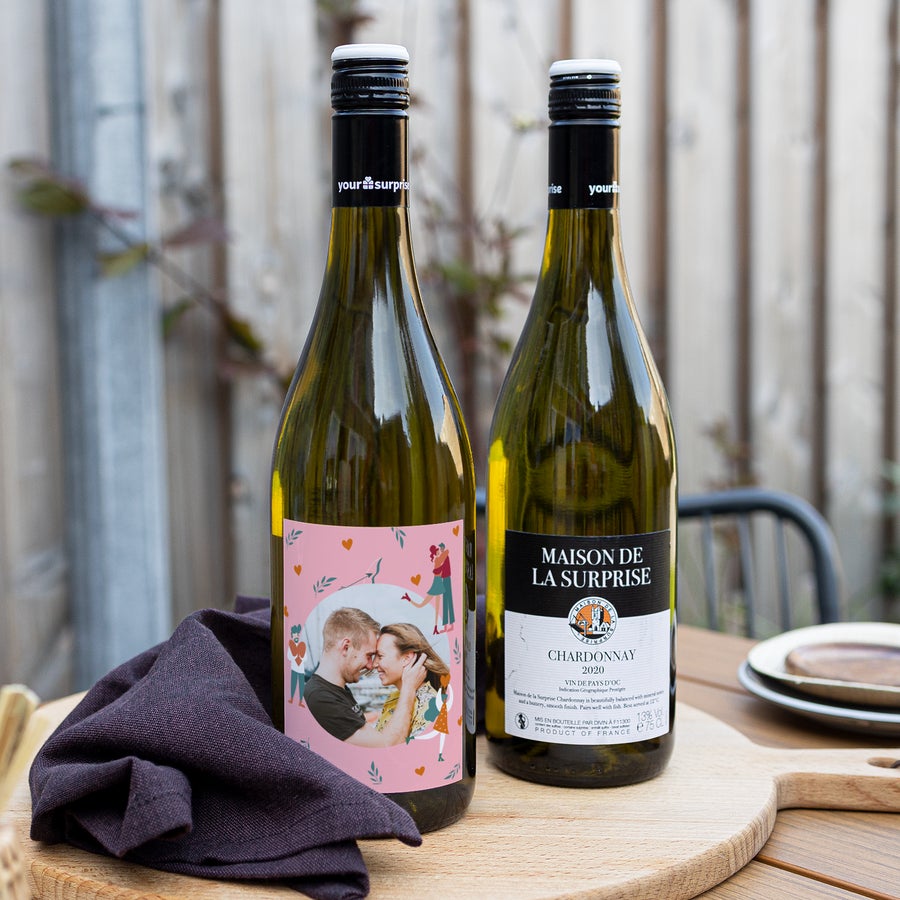 Two Chardonnay bottles with a personalized label, one showing a couple's photo and the other the wine brand.