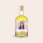Personalized limoncello bottle with a custom label printed with a smiling photo and the name "KATE'S PREMIUM BLEND"