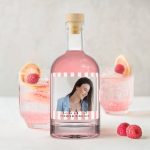 Pink gin bottle with a custom photo label, showing a woman smiling, and the text LEAs Premium Pink Gin.