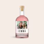 Pink gin bottle with a personalized label, printed with a photo of two women and the text Jemma