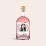 Personalised pink gin bottle with a photo of a woman and "Kate's" on the custom label