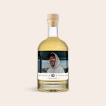 Personalized whisky bottle with a photo of a smiling man printed on the label, ideal for a unique gift